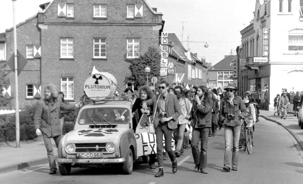 Der Protest nimmt Fahrt auf: Hinterm R 4 ziehen 1977 zum ersten Osterspaziergang knapp 1000 Kernkraftgegner durch die Kalkarer Straßen. Auf dem Dach des kleinen Kultautos lag ein Fass mit der Aufschrift "Plutonium". Bis zum Schnellen Brüter kam der Zug nicht, dafür hatte ein Polizeiaufgebot von 2000 Beamten gesorgt. FOTO: Evers, Gottfried Brüterdemo